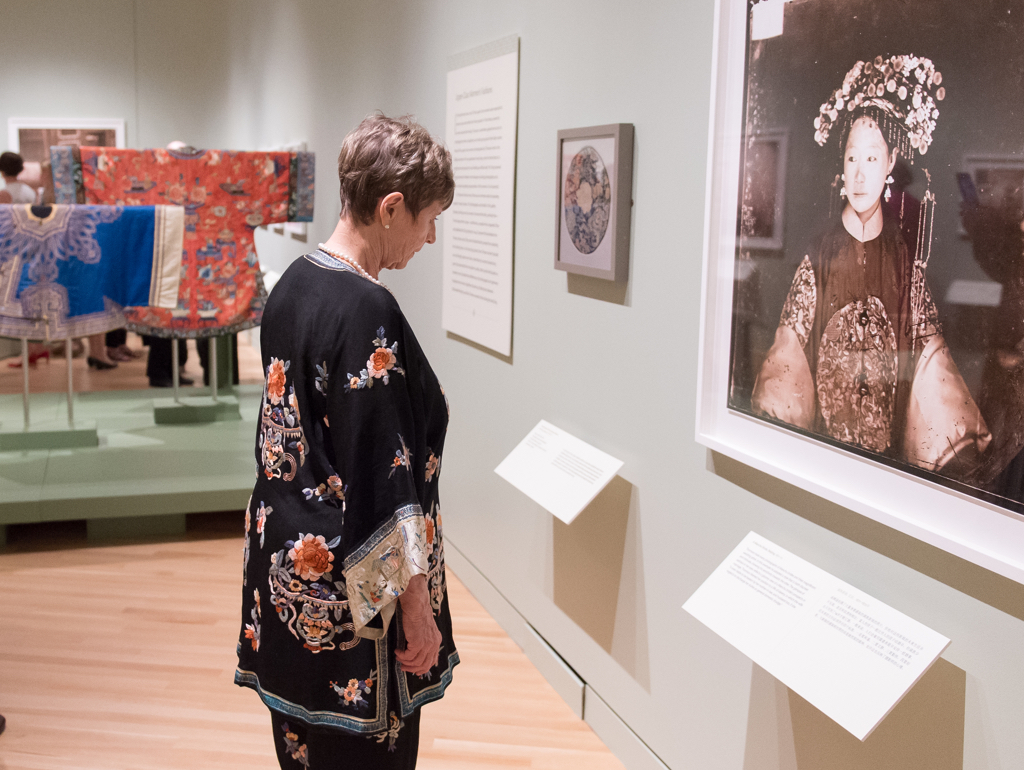 Woman looking at old photograph portrait