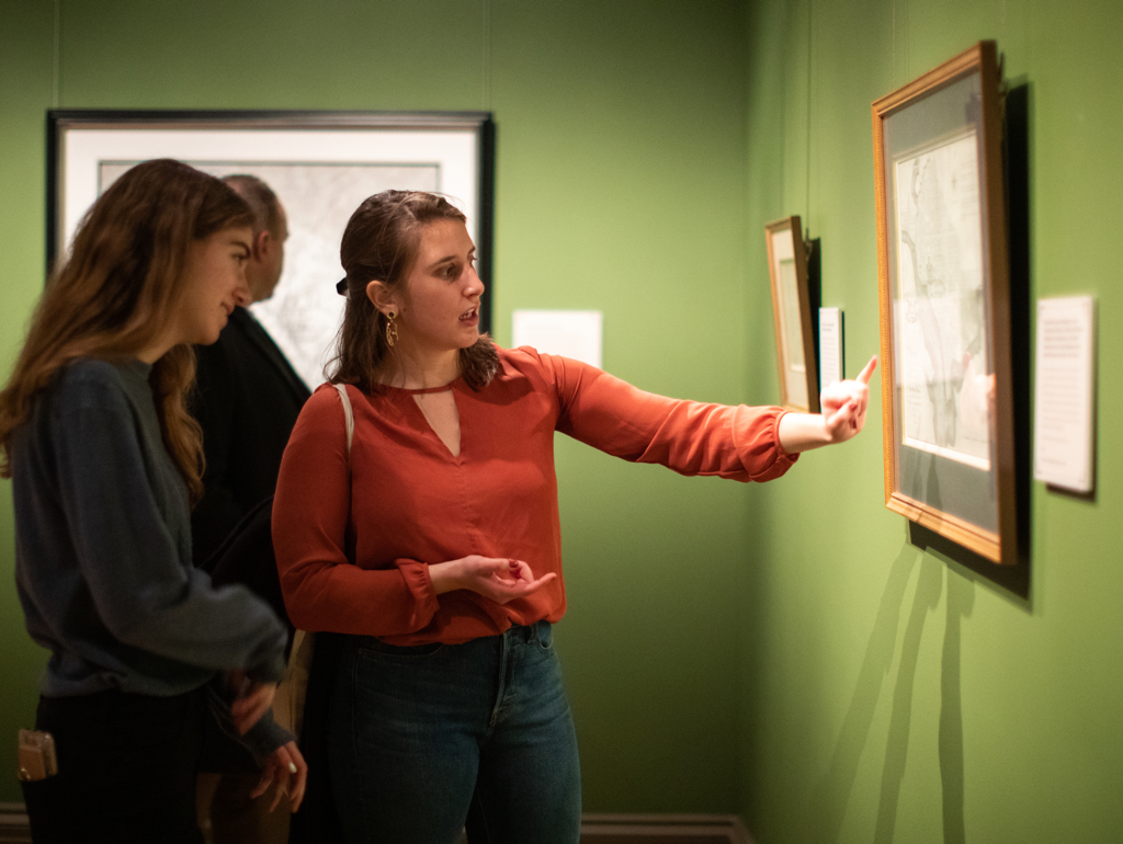 Two college students look at print in gallery